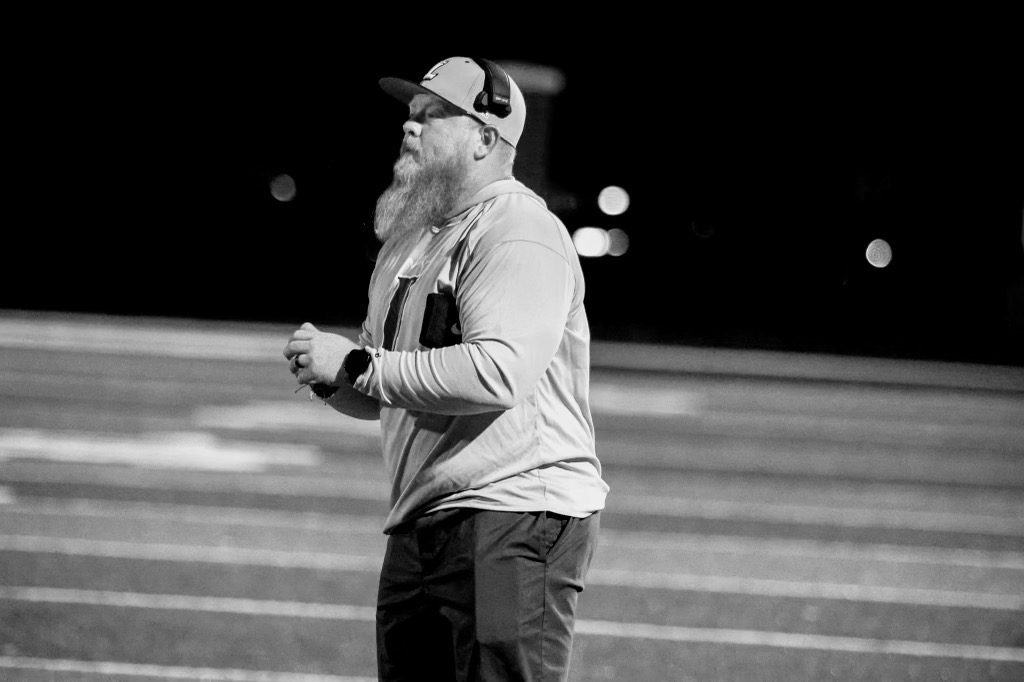 Brandon Compton coaching on the sideline on a Friday night